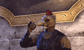 a statue of a cat with a long nose and a red hat