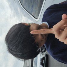 a person making a heart sign with their finger