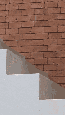 a staircase with a brick wall behind it and the words tv simpe