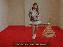 a woman is dancing in front of a cake with the words " and you ask where the hell i 've been "