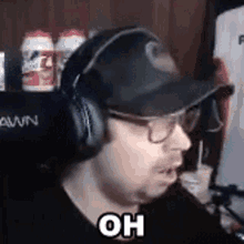 a man wearing headphones and a hat with the word oh on it .