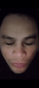 a close up of a man 's face with his eyes looking at the camera