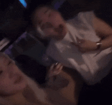 a blurry photo of a man holding a phone