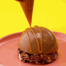 a chocolate dessert with caramel being poured on top of it