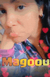 a woman 's face is surrounded by hearts and the word magool is visible