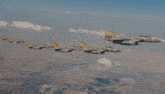a group of fighter jets are flying in a row over a city