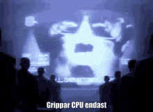 a group of people looking at a screen that says grippar cpu endast