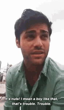 a man in a green shirt is saying it 's nuts i mean a boy like that that 's trouble .