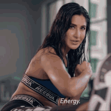 a woman wearing a blue reebok sports bra and black reebok underwear