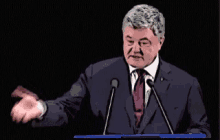 a man in a suit and tie is giving a speech in front of two microphones with the words закуси written above him