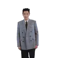 a man in a suit and tie is standing with his arms in the air