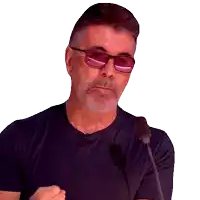 a man wearing sunglasses and a black shirt is speaking into a microphone