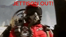 a blurry picture of a jet pilot with the words " jettison out " written in red