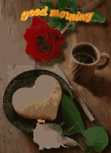 a heart shaped cookie on a plate next to a cup of coffee