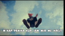 a person is flying through the air with the words " m'kap panika kur jam mir me krejt " below them