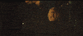 a man is hanging upside down in a dark room with his mouth open .