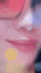 a close up of a person 's face with a pink sunglasses on