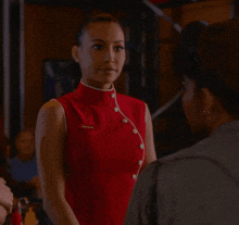 a woman wearing a red uniform with the word shanghai on the pocket
