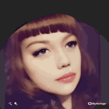 a close up of a woman 's face with a myheritage logo on the bottom right