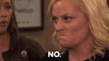 a woman is making a funny face and saying `` no '' .