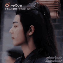 a close up of a man 's face with a weibo logo on the bottom