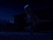 a dinosaur is standing in front of a building in the dark