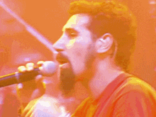 a man singing into a microphone with his mouth open