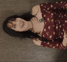 a woman in a floral dress is laying on the floor