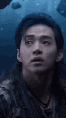 a close up of a man 's face in the water looking at something