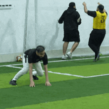 a man wearing a yellow jersey with the number 8 on it is running on a soccer field