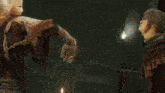 a hand is touching a woman 's forehead with a fireball coming out of it