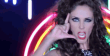 a woman with curly hair is making a phone call sign with her hands .
