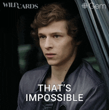 a young man sitting in a car with the words that 's impossible