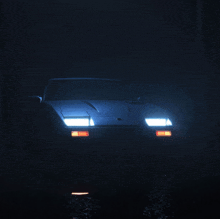 a car is lit up in the dark and has a license plate that says ' aa ' on it