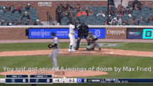 a baseball game is being played in front of a meijer advertisement