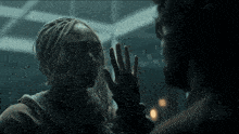 a man and a woman are touching each other 's faces
