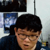 a man wearing glasses and a t-shirt that says star on it