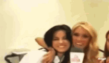 a group of women are posing for a picture and smiling .