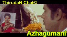 a man is holding a picture of a woman in front of a sign that says azhagumuni