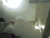 a room with a light on the ceiling and a white blanket on the floor