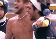 a group of men are standing next to each other and one of them is wearing a penguin costume .