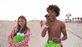 a man without a shirt is talking on a cell phone while a woman holds a stuffed animal .