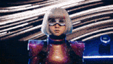 a woman in a futuristic costume looks at the camera with a blurred background