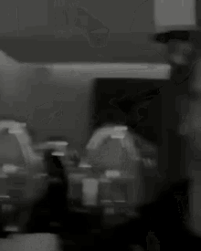 a blurry black and white photo of a man 's face .