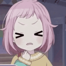 a close up of a girl with pink hair making a funny face .