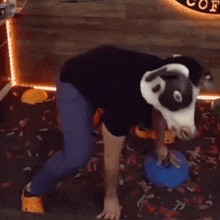 a person wearing a cow mask is standing in front of a sign that says coffee