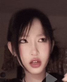 a close up of a woman 's face with a play button in the background