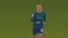 a soccer player wearing a blue jersey with the number 2 on it