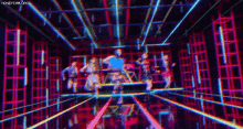 a group of people are dancing in a room with a lot of lights .