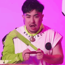 a man wearing a white shirt with the word nokingy on the neck